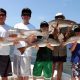 five people each carrying fish